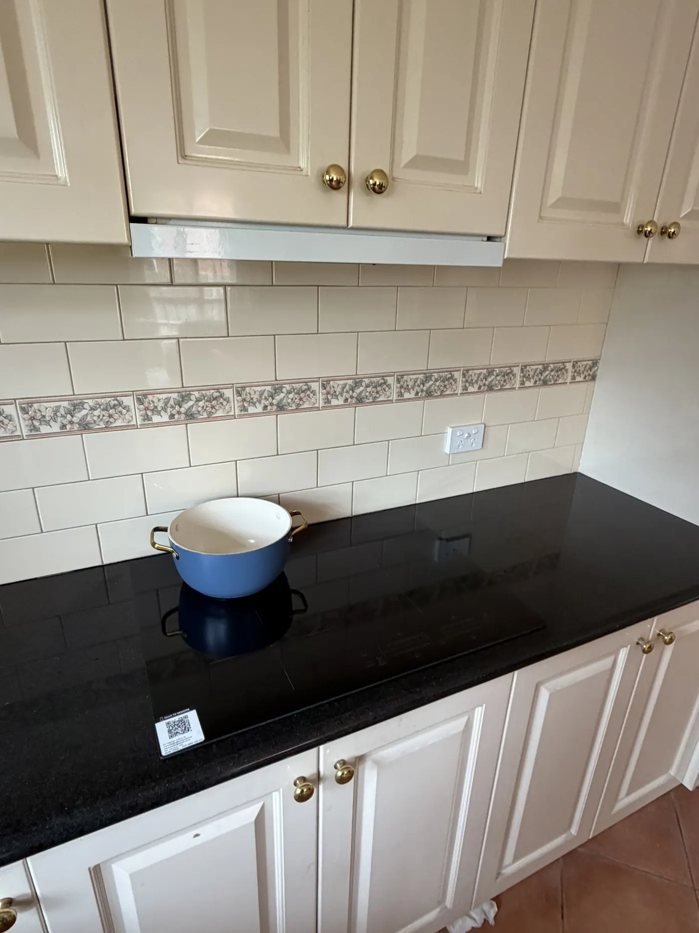 Induction cooktop installed in a white country kitchen by Pender Electrical