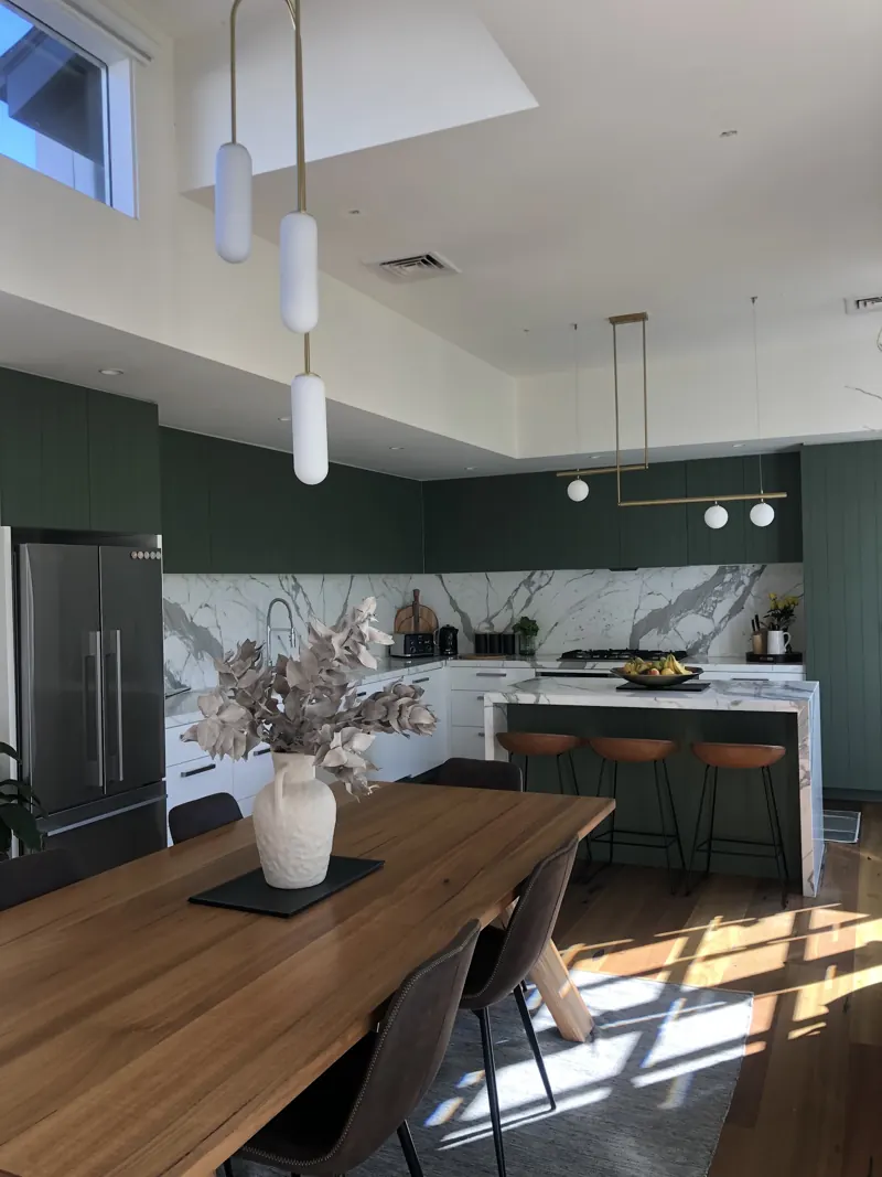 Renovated kitchen and dining with pendant and linear lighting